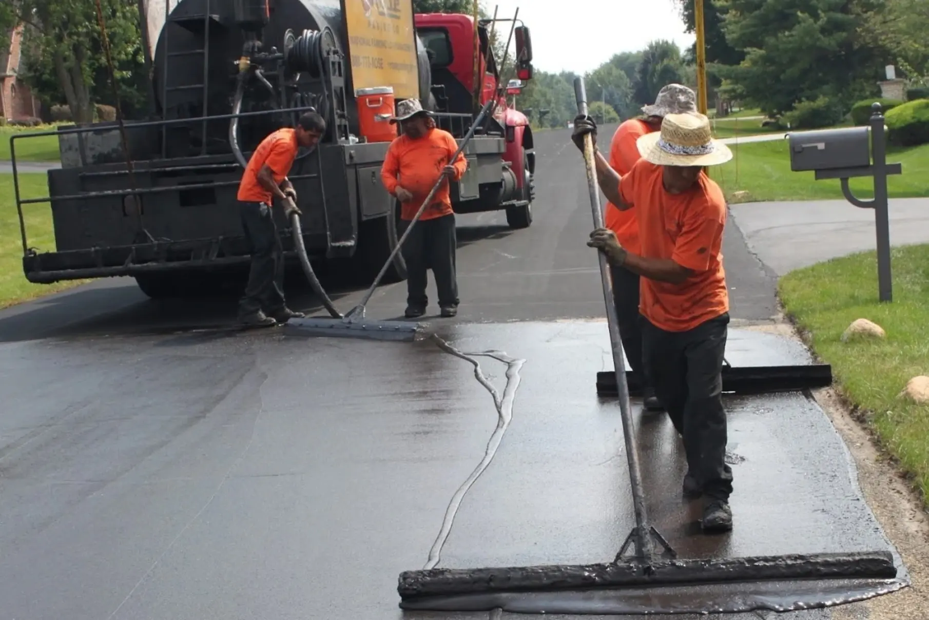 Pave N Seal crew sealcoating a residential driveway in Baltimore